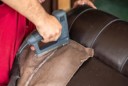 man reupholstering a chair